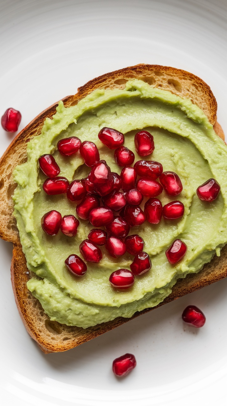 An image of avocado spread on toast, topped with pomegranate seeds.